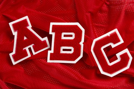 Red letters A,B,C shot on red sports jersey materialの写真素材