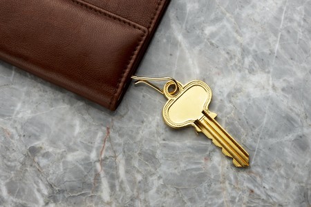 brown leather key case with key shot on marble table, space for copyの写真素材