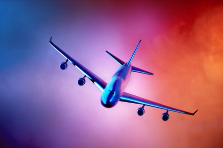 Oncoming Jet plane shot on orange blue sky with room for copyの写真素材