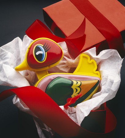 Colorful toy duck shot in red gift box with ribbon, hi res scan from filmの写真素材
