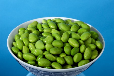 Close up shot of a bowl of fresh green edamames with space for copy