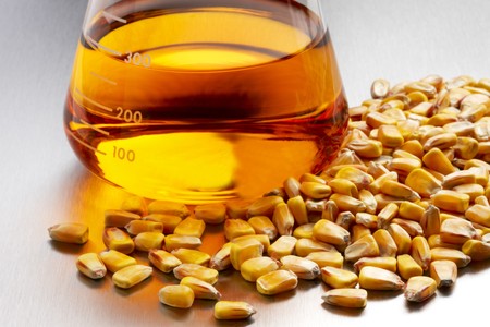 Beaker of ethanol with corn kernals shot in laboratory on white background with soft shadowの写真素材