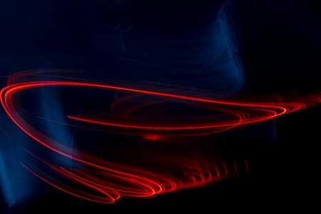 Streaks of bright red lights shot on dark background with space for copyの写真素材