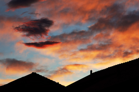 sunset in Italy, roofs and beautifull sky with red sunset cloudsの写真素材