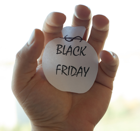 The black Friday inscription on a piece of white paper. Black friday ads. Human hand.の写真素材
