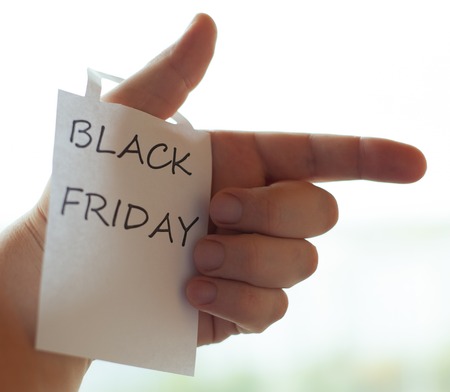 The black Friday inscription on a piece of white paper. Black friday ads. Human hand.の写真素材