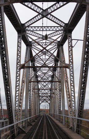 Looking straight down a train bridge that is no longer in use.