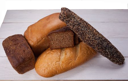 Tasty rustic bread on red wooden tableの写真素材