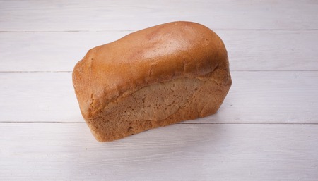 Tasty rustic bread on red wooden table