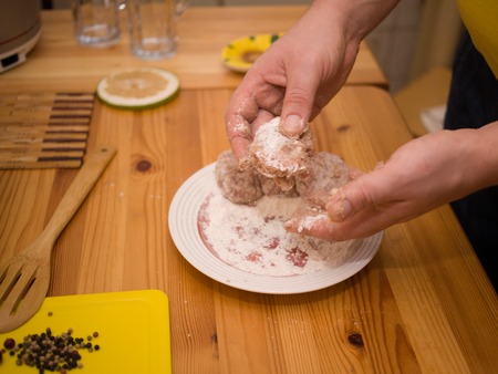 Mens hand take minced meat for meatballsの写真素材