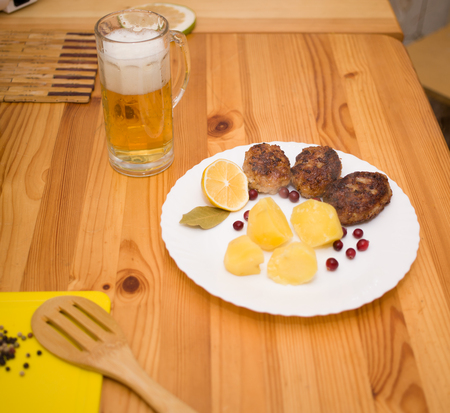 Wiener schnitzel and boiled potatoes with sliced lemonの写真素材