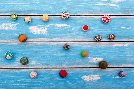 Collection of rubber bounce balls on wooden blue background