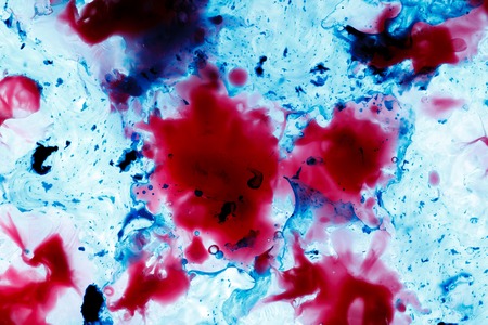 Wax blurs in water. Abstract red and blue background