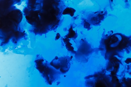 Wax droplets in water. Abstract blue backgroundの写真素材