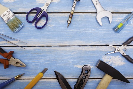 Pattern of hammer, pliers, scissors, knife, soldering iron, brush, screwdriver wrench at rustic...