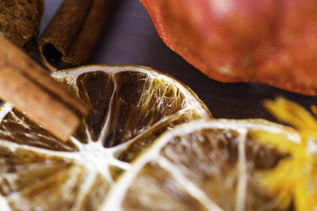 Pomegranate, surrounded by autumn gifts. Slices of lemon close-up