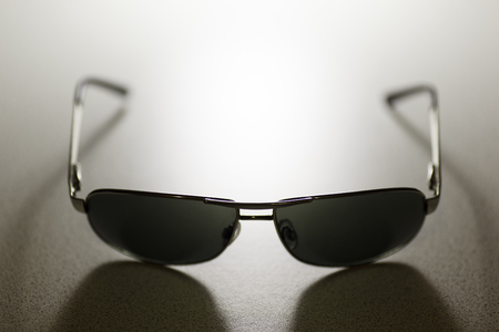 Stylish sunglasses on white background with silvery rimの写真素材