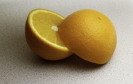 The two halves of the Orange close-up on light backgroundの写真素材