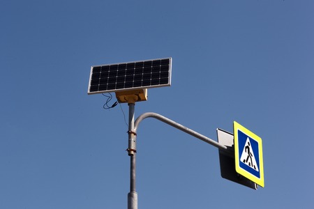 Sign of pedestrian crossing on solar battery. Alternative energyの写真素材
