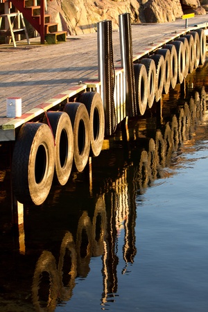 Boat mooring and wooden walkway with refelctionの写真素材