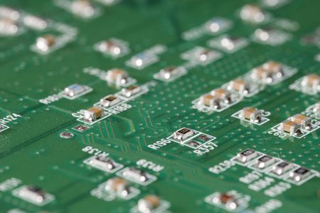 A detailed macro shot of a Integrated Circuit Board, looking like roads and cabins in a village,...