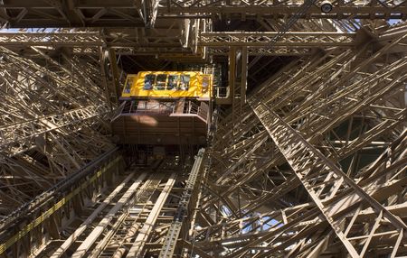 The elevator taking tourists up to the various levels of the Eiffel tower in Paris, Franceの写真素材