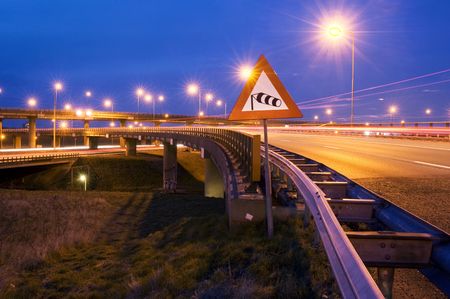 The windvane on a sign, warning the traffic for heavy winds on the motorway overpassの写真素材