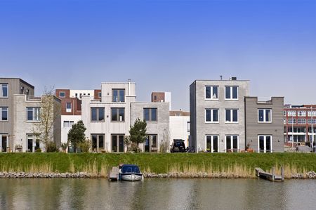 A modern housing development, constructed of geometrical patterns and straight angles, using various natural building materialsの写真素材