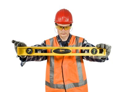 A construction worker holding a level horizontal, clipping path included