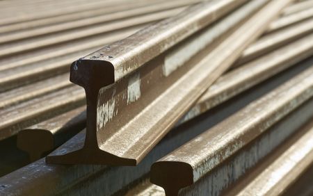 A stack of rusted railroad tracks, shot with backlight and a shallow depth of fieldの写真素材