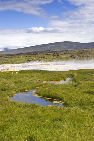 The hot springs and oasis on the Kjolur Highland route in Iceland at Hveravellir. The vatnajokull glacier is visible in the distanceの写真素材