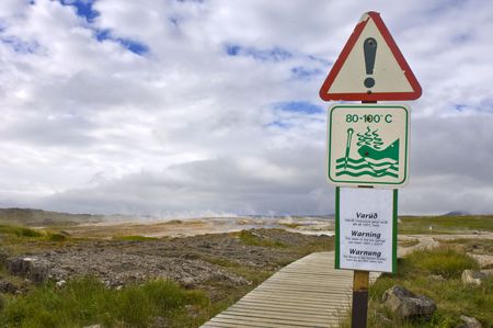Warning sign for Geothermal activity and boiling water erupting from the earth in the Hveravellir Hot Spring area in Icelandの写真素材