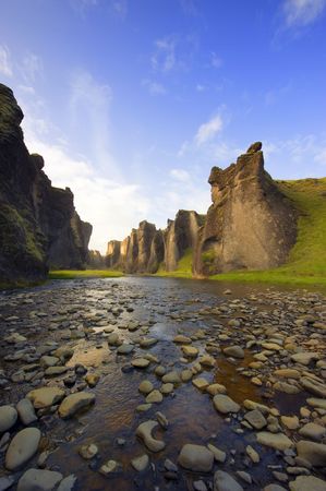 An ancient Canyon in Hunkarbakkar, Iceland, where the different layers of volcanic branch pipes have created hard structures, which still stand erect, when over time, the softer ashes and eruption debris has been eroded away, forming the erratic banks of の写真素材