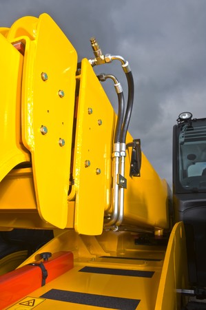 A closue-up view on a hydraulic lifting arm of an industrial forkliftの写真素材
