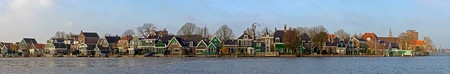 The old, picturesque houses of Zaanse Schans along the river side of the Zaan on a cold winter morningの写真素材