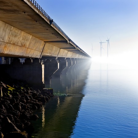 The Oosterschelde Stormvloedkering (Scheldt storm barrier) - a modern day marvel of technology and engineering - on a hazy winter day with calm weatherの写真素材