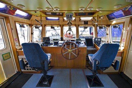 The wheelhouse of a fireboat with various navigational equipmentの写真素材