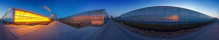 A seamless 360 degree panoramic image of several huge glasshouses at duskの写真素材