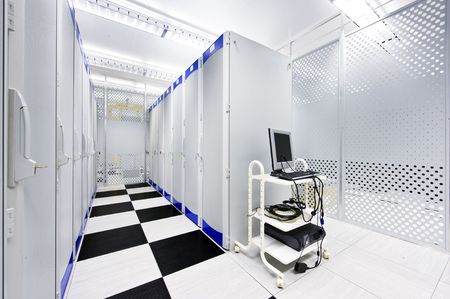 Clean suite in a data center with the perforated doors of server racks and a computer cartの写真素材