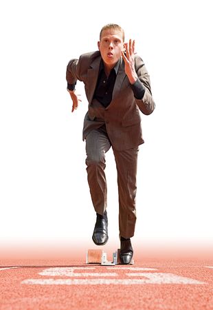 Businessman leaving the starting blocks - a metaphor of starting a new businessの写真素材