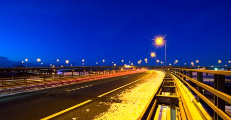 Cars passing by on a motorway junction on a winter evening