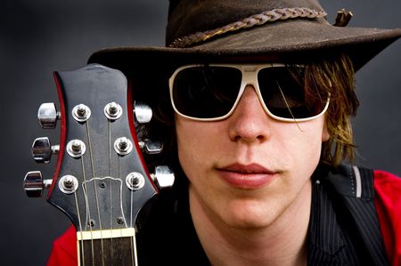 Portrait of a jazz rock guitarist wearing an old hat の写真素材