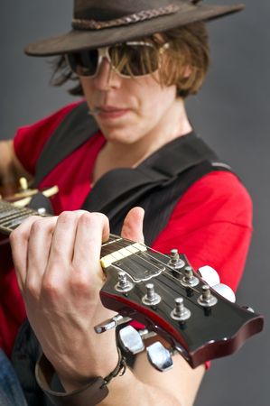 A guitarist getting the maximum from his guitar. Selective focus on the musicians left hand