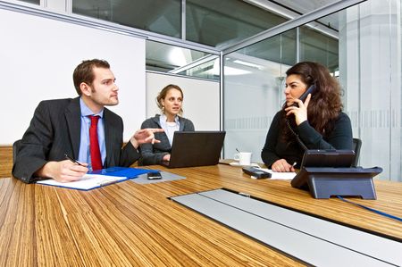 A small business team in a cubicle conference room during a meetingの写真素材