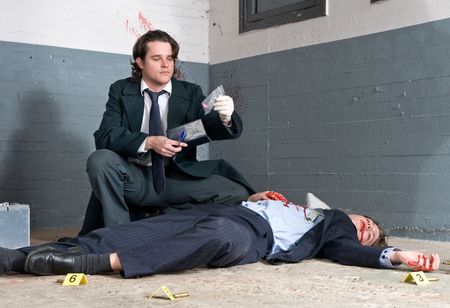 Police inspector discovering a controlled substance during his murder investigationの写真素材
