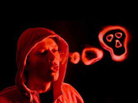 Hooded figure blowing smoke rings, lit from the right side by a red light