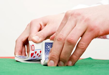 Dealer's hands shuffling cards during a poker gameの写真素材