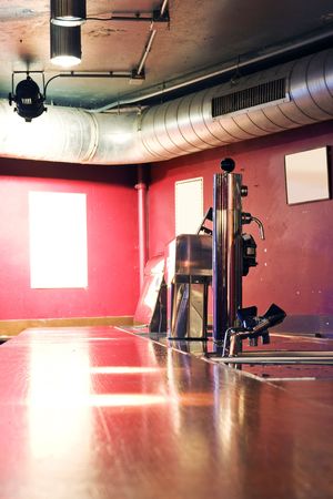 A scruffy bar at a nightclub wity a computerized beer tapの写真素材
