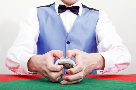 A dealer shuffling cards at a poker tableの写真素材