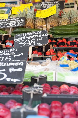 Fresh fruits at a greengrocer's stall focus on the strawberries
